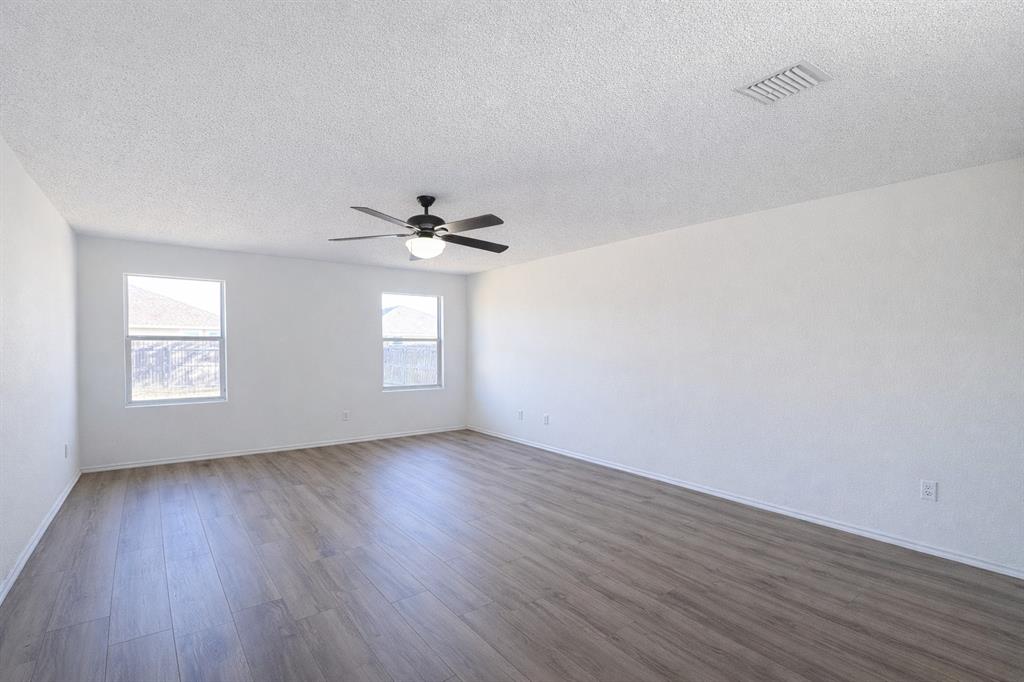 2512 Mitchell Lane Anna, TX 75409 - Photo 7 of 8 a view of an empty room with wooden floor and a window