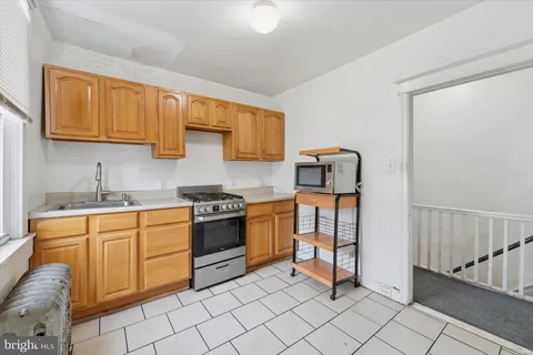 a kitchen with stainless steel appliances granite countertop a stove and a refrigerator