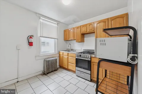a kitchen with white cabinets and appliances