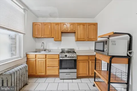 a kitchen with stainless steel appliances granite countertop a stove and a microwave