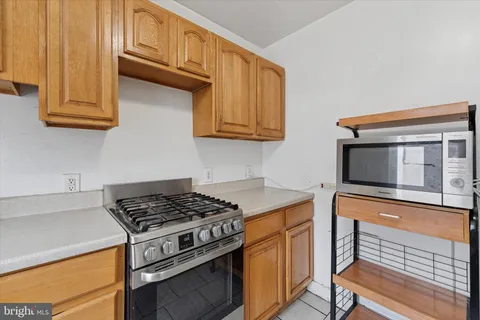 an empty room with a window and a ceiling fan