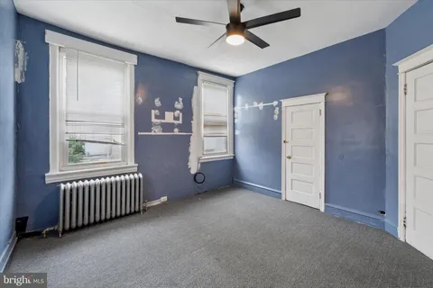 a bathroom with white walls and toilet