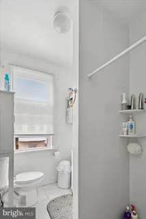 a view of a house with a door and wooden fence