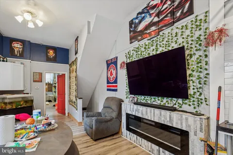 a view of room with a ceiling fan and wooden floor