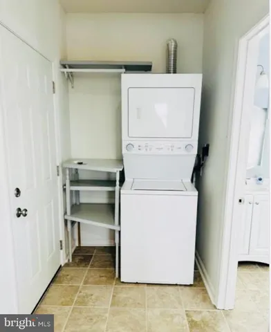 a living room with patio furniture and a floor to ceiling window