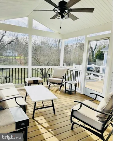 a view of a patio with table and chairs with wooden floor and fence