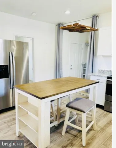 a view of a kitchen island wooden floor and a window