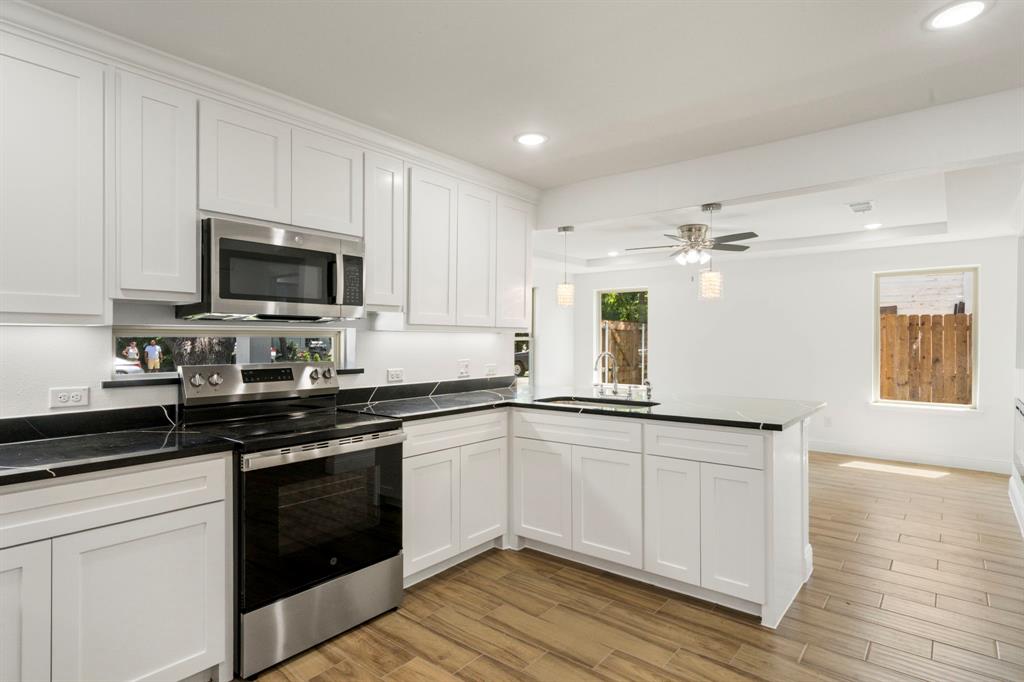 a kitchen with stainless steel appliances granite countertop a stove and a sink