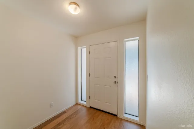 a kitchen with a cabinets wooden floor and a window