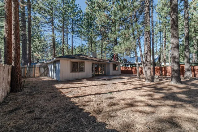 a view of a house with a large window and a tree