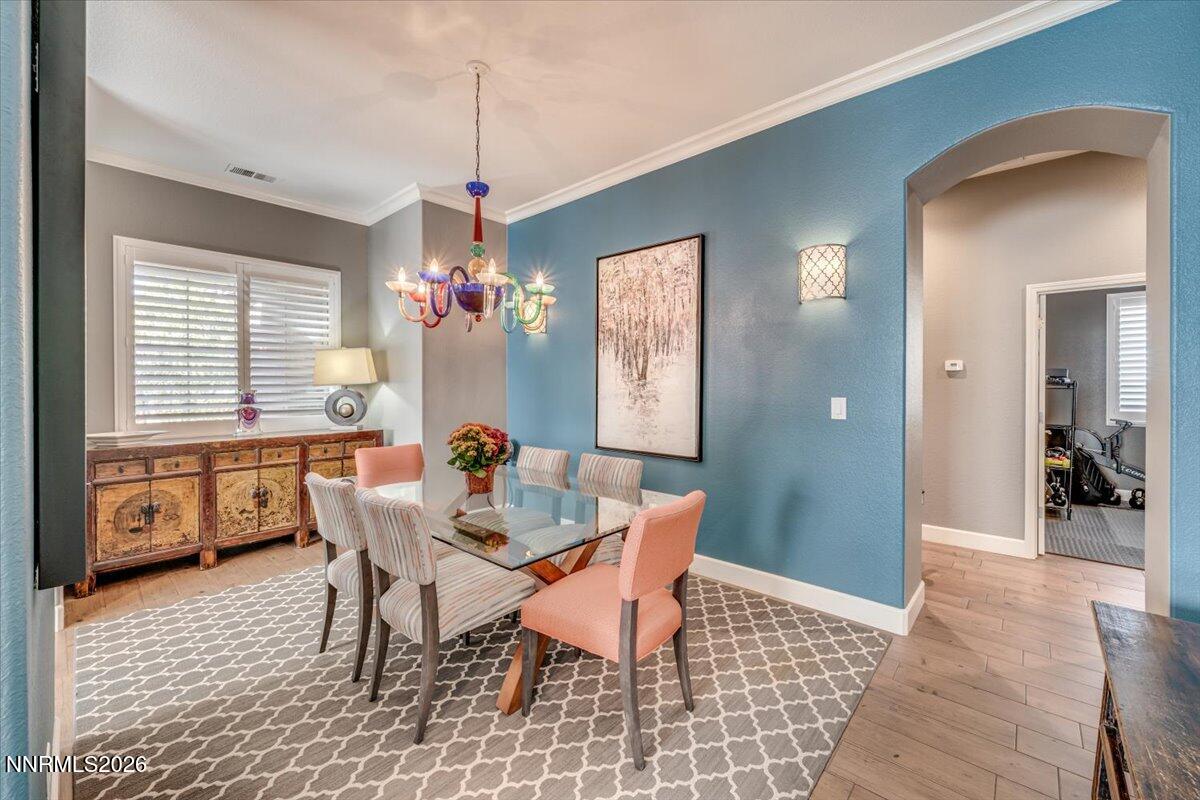 10562 Thistle Berry Court Reno, NV 89521 - Photo 13 of 44 a dining room with furniture a chandelier and wooden floor