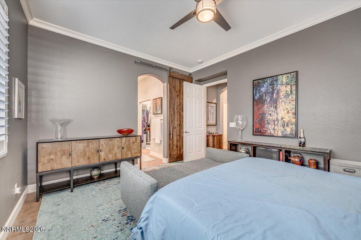 10562 Thistle Berry Court Reno, NV 89521 - Photo 25 of 44 a bedroom with a bed and a chandelier
