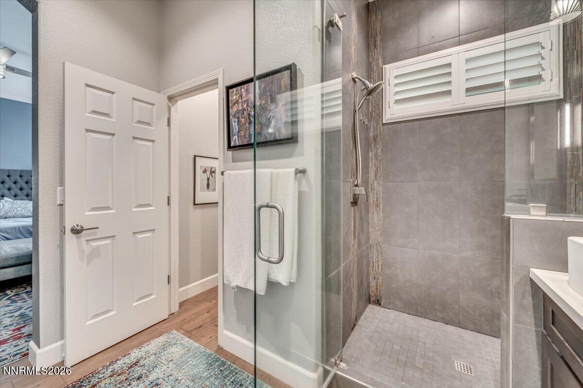 10562 Thistle Berry Court Reno, NV 89521 - Photo 28 of 44 a bathroom with a shower and mirror