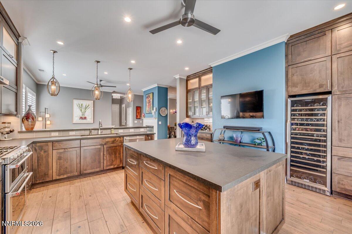 10562 Thistle Berry Court Reno, NV 89521 - Photo 8 of 44 a kitchen with granite countertop a sink and a stove top oven with wooden floor