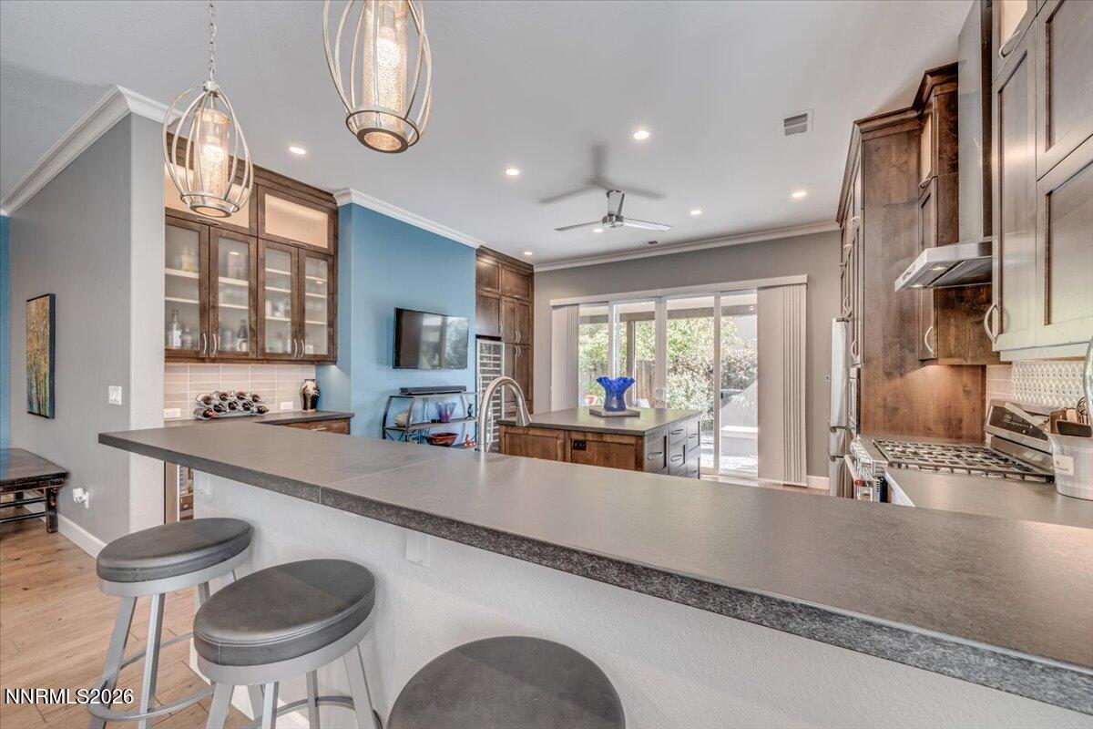 10562 Thistle Berry Court Reno, NV 89521 - Photo 10 of 44 a large kitchen with a table and chairs