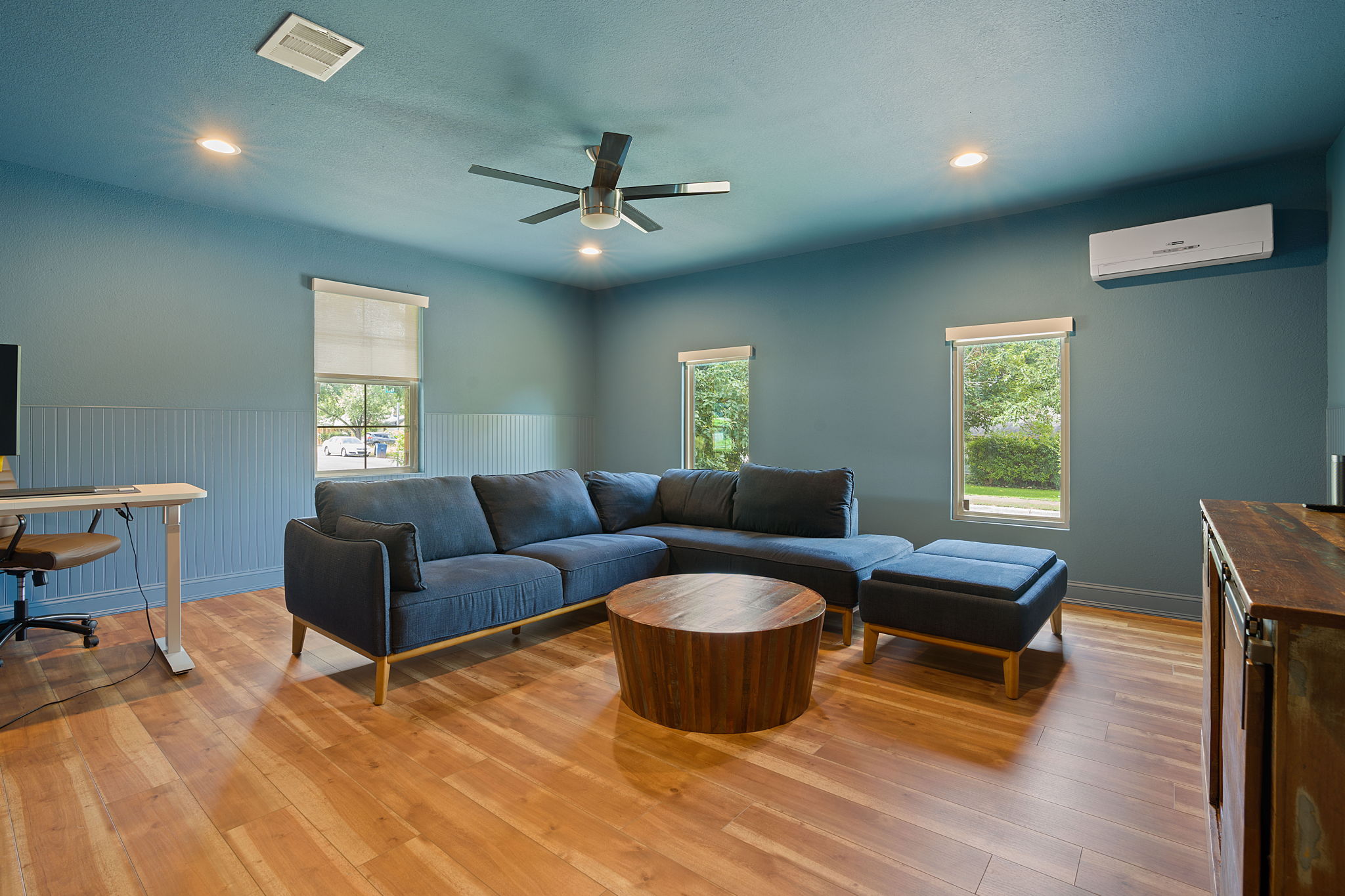 7110 Tawny Circle Austin, TX 78745 - Photo 16 of 30 Living room with light wood-style flooring, wainscoting, a ceiling fan, and recessed lighting