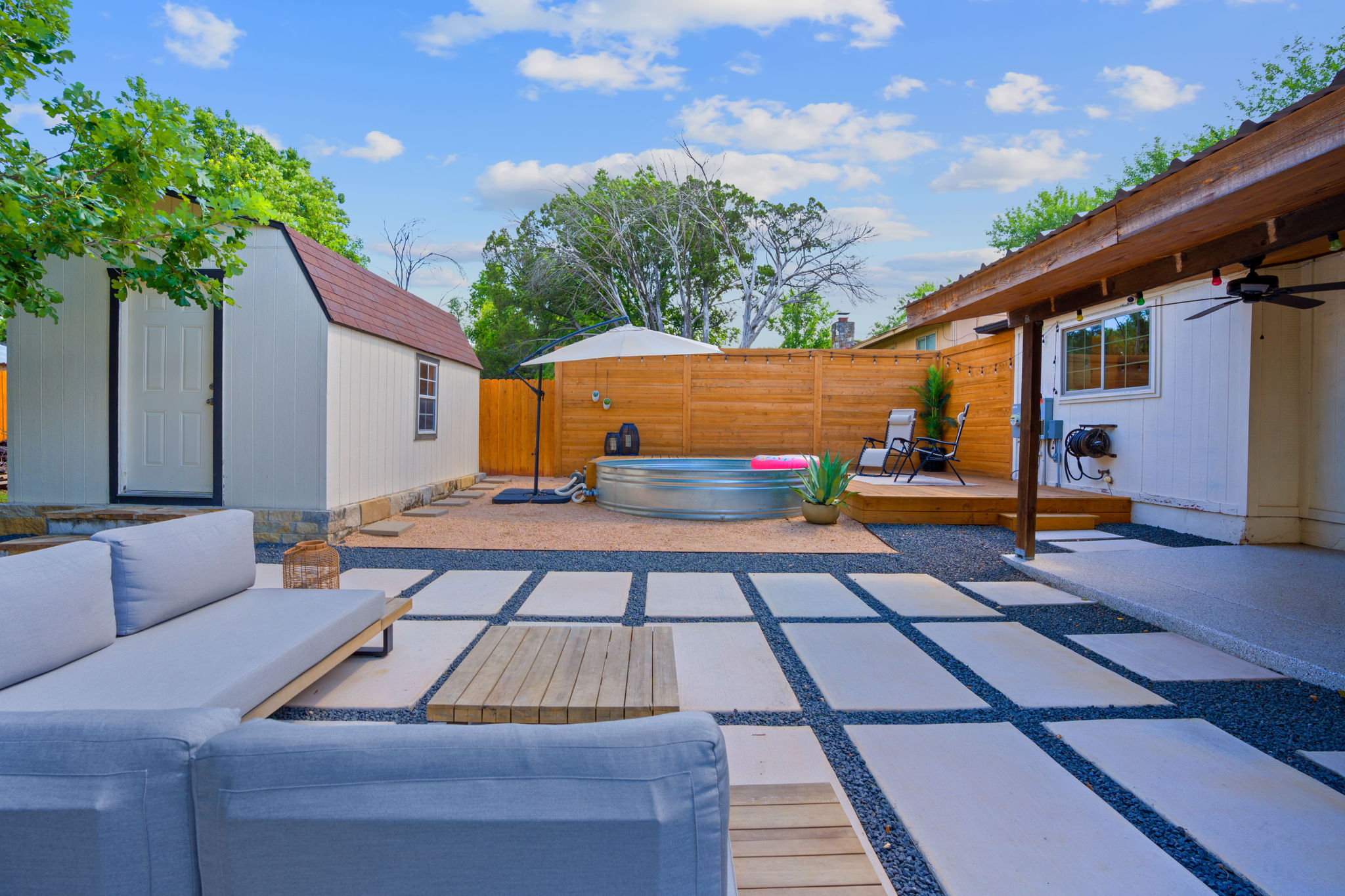 7110 Tawny Circle Austin, TX 78745 - Photo 24 of 30 Upgraded backyard fence and pavers featuring a wooden deck, a patio area, and a cowboy pool