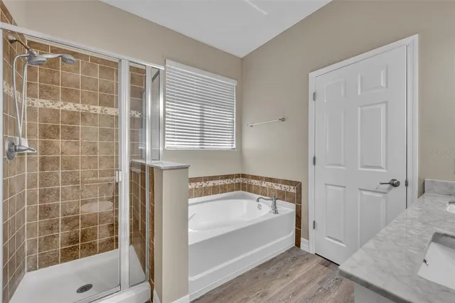 a bathroom with a tub and shower