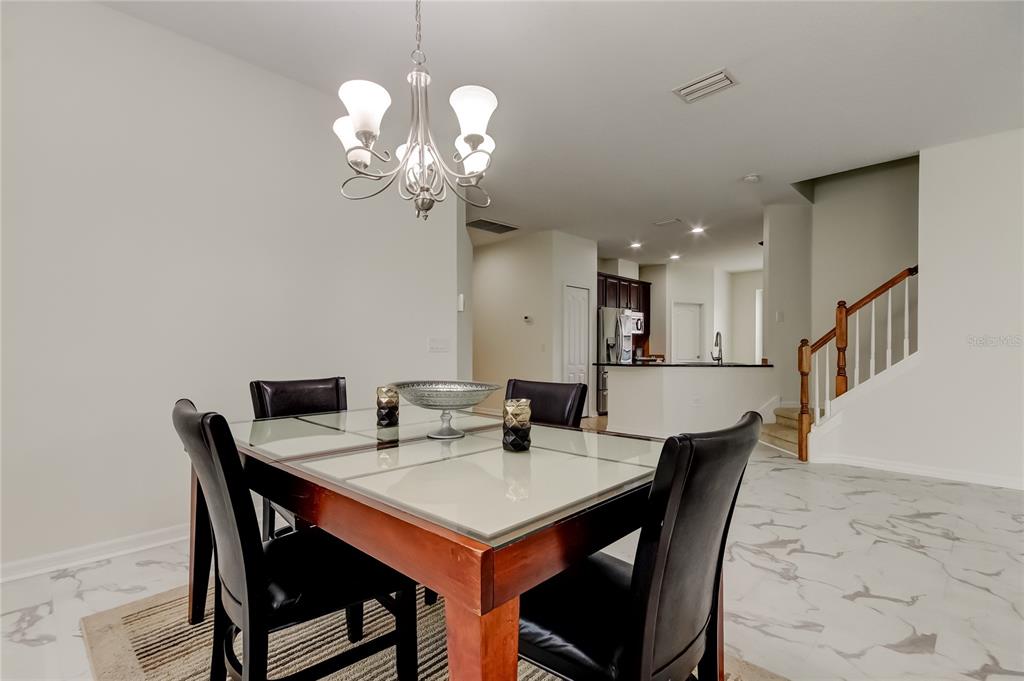 12747 Tikal Way Trinity, FL 34655 - Photo 21 of 40 a view of a dining room with furniture and wooden floor