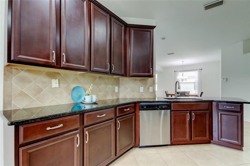 12747 Tikal Way Trinity, FL 34655 - Photo 3 of 40 a kitchen with granite countertop cabinets and stainless steel appliances