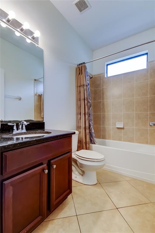 12747 Tikal Way Trinity, FL 34655 - Photo 34 of 40 a bathroom with a toilet sink and shower