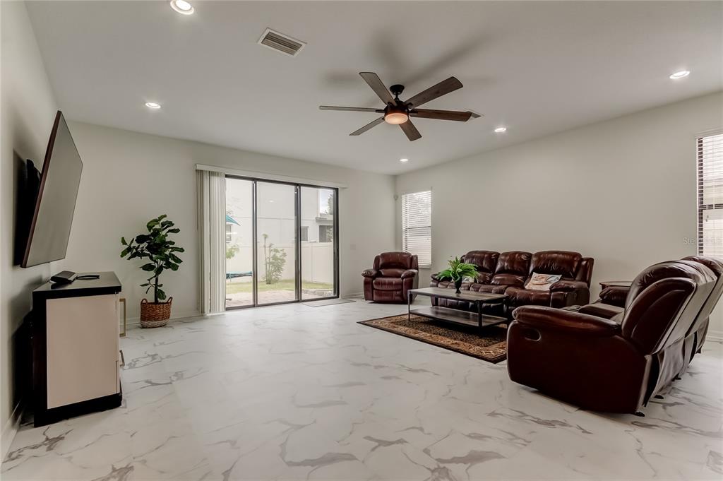 12747 Tikal Way Trinity, FL 34655 - Photo 9 of 40 a living room with furniture and a flat screen tv