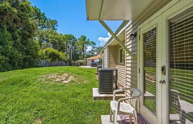 a view of house with backyard