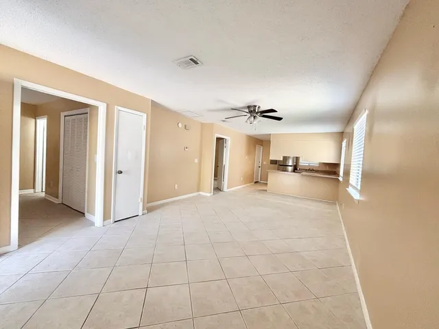 a view of a kitchen with a sink and a refrigerator