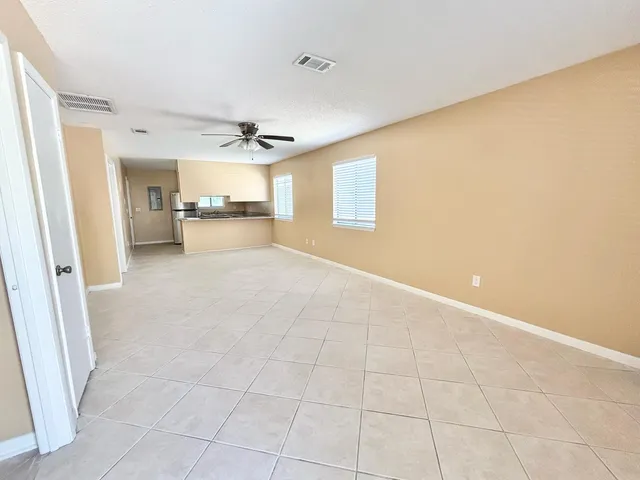 a view of a livingroom with a ceiling fan and window