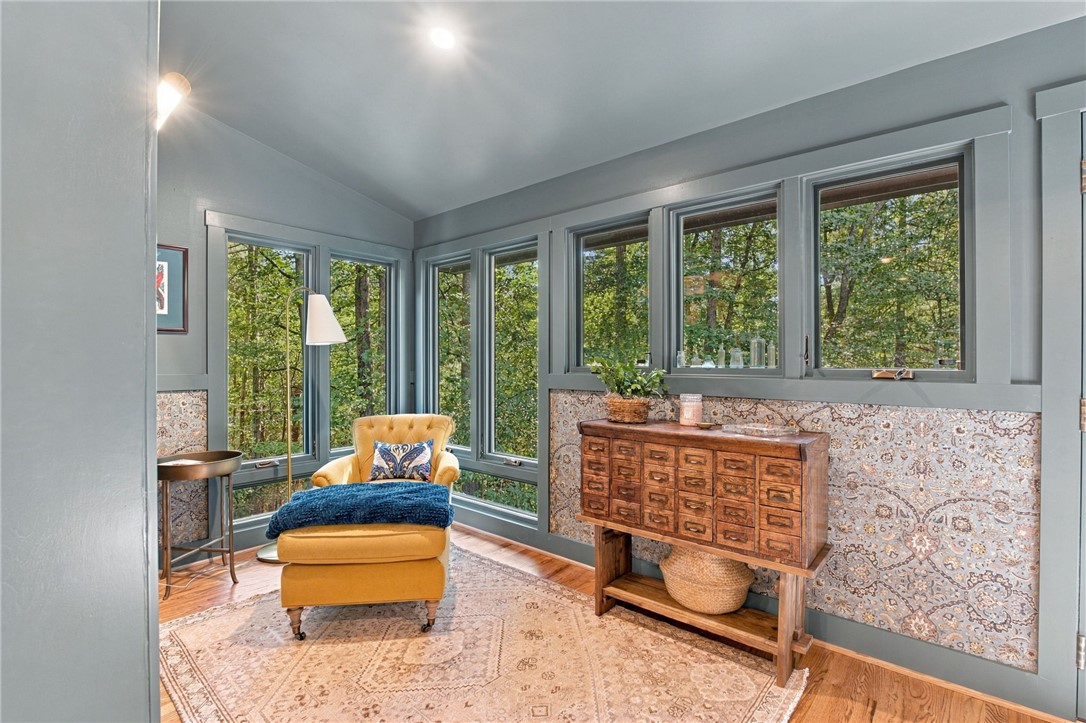 604 Ridgecrest Drive Clemson, SC 29631 - Photo 34 of 50 A wall of windows frames leafy forest views from this inviting sitting area.