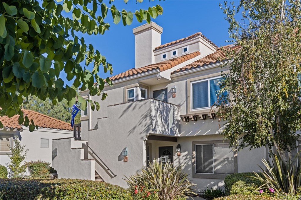 19 Brisa Ribera Rancho Santa Margarita, CA 92688 - Photo 12 of 16 a view of a swimming pool with a lawn chairs under palm trees