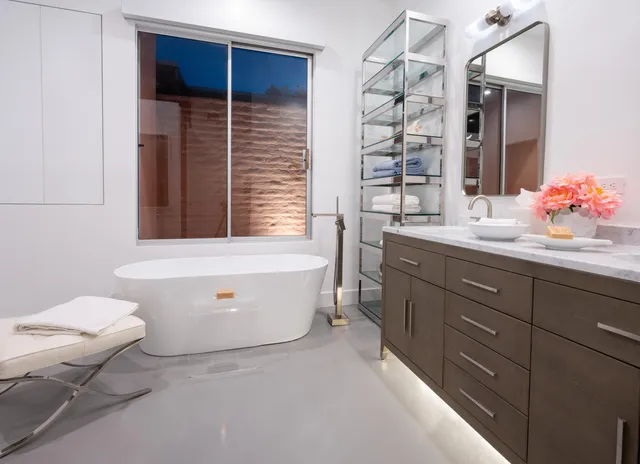 a white bath tub sitting next to a white sink