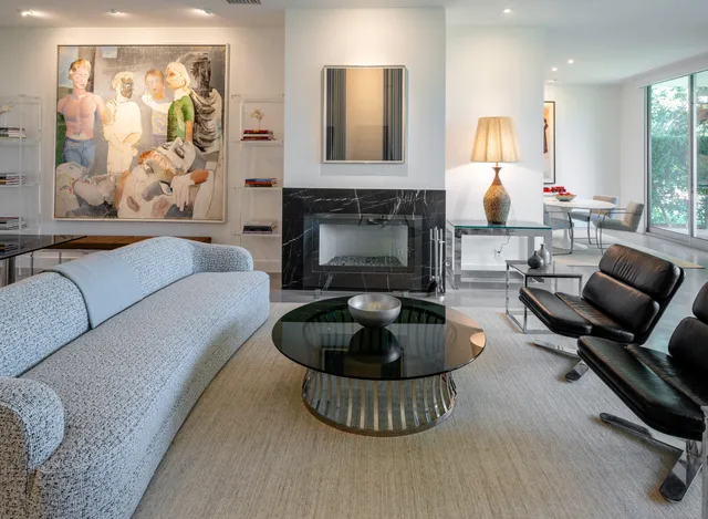 a living room with furniture and a fireplace