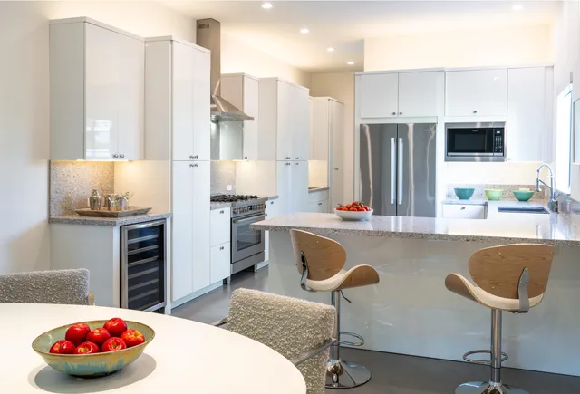a kitchen with stainless steel appliances granite countertop a sink and a refrigerator