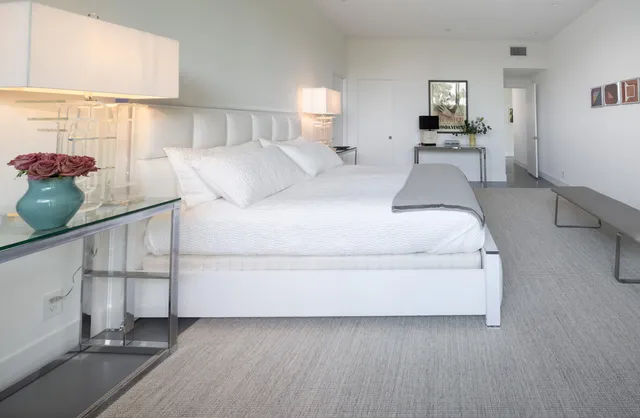 a bed sitting in a bedroom next to a window