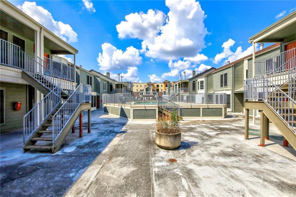 2529 Rio Grande Street, Unit 93 Austin, TX 78705 - Photo 16 of 19 The property offers exterior stairs with railings and a paved courtyard area