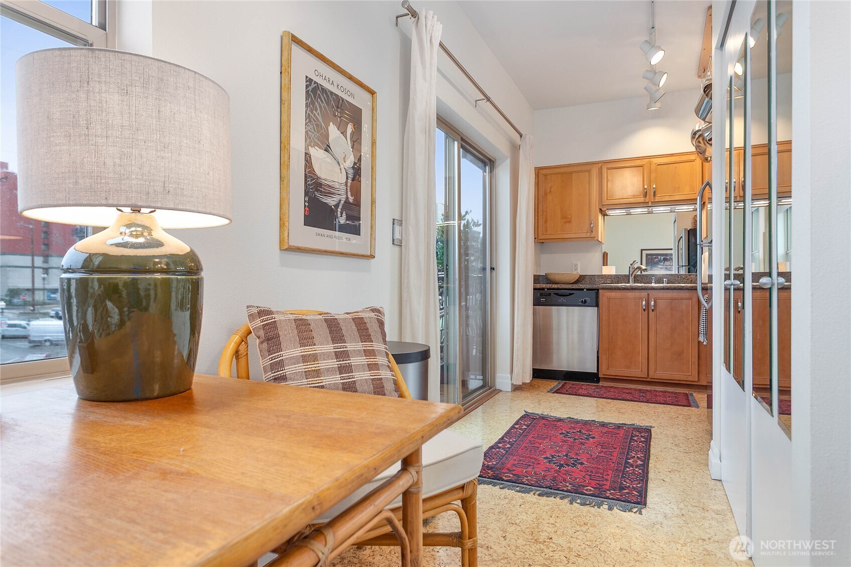 1310 10th Street, Unit 408 Bellingham, WA 98225 - Photo 13 of 33 a kitchen with stainless steel appliances kitchen island granite countertop a refrigerator a stove and white cabinets with wooden floor