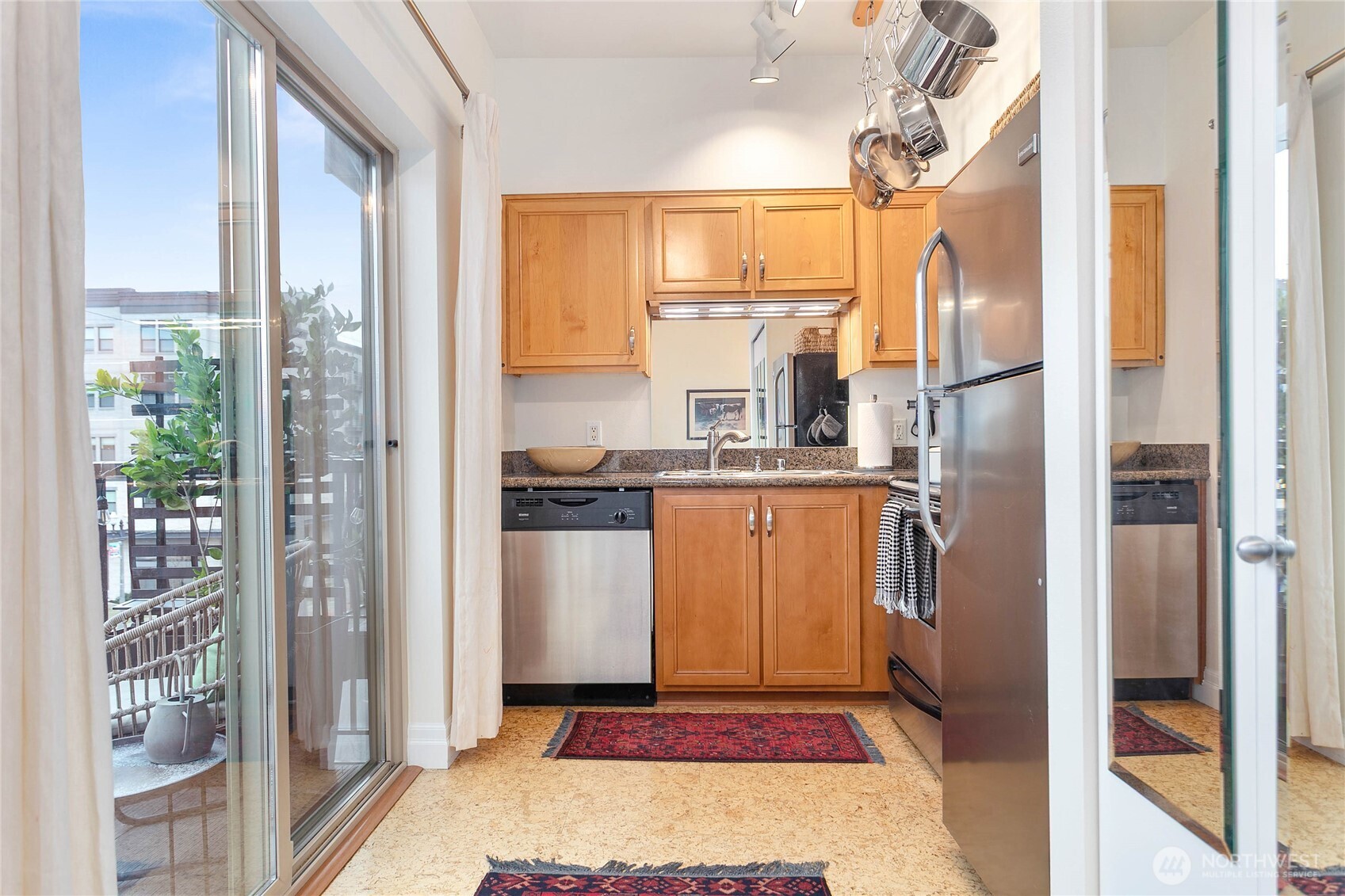 1310 10th Street, Unit 408 Bellingham, WA 98225 - Photo 14 of 33 a kitchen with refrigerator a stove and cabinets