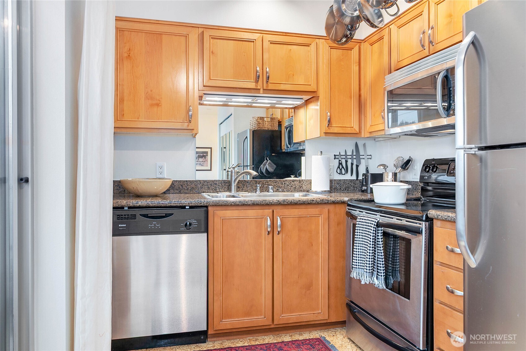 1310 10th Street, Unit 408 Bellingham, WA 98225 - Photo 15 of 33 a kitchen with stainless steel appliances granite countertop a refrigerator and a stove top oven