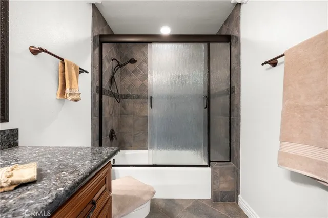 a view of a livingroom with a ceiling fan and window