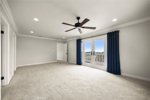 an aerial view of residential houses with outdoor space and trees