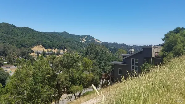 a view of a house with a mountain in the background