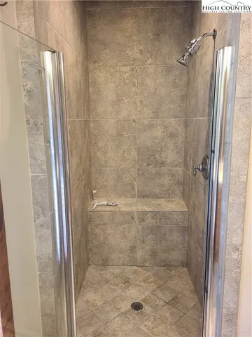 a bathroom with a glass door shower