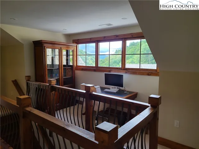 a view of a yard with plants and a bench