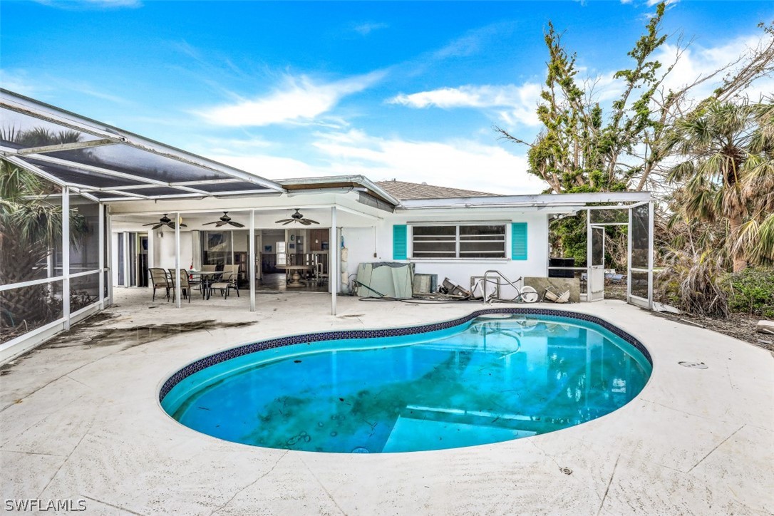 591 Boulder Drive Sanibel, FL 33957 - Photo 11 of 29 a view of a house with swimming pool and porch