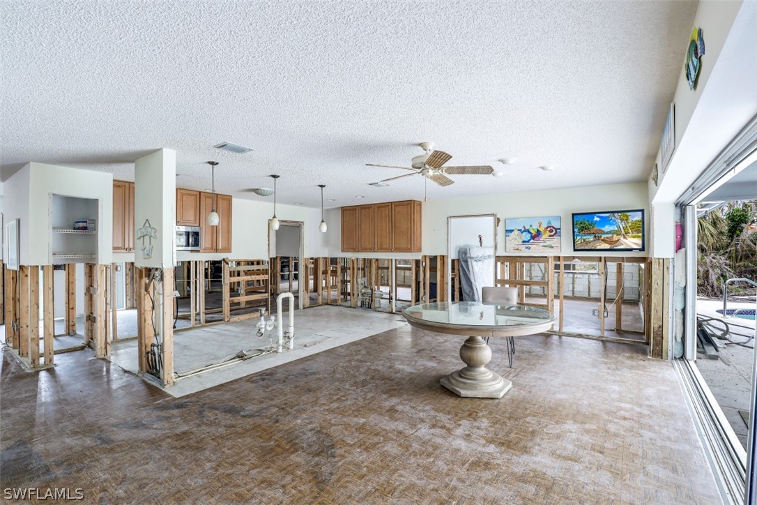 591 Boulder Drive Sanibel, FL 33957 - Photo 12 of 29 a view of a living room and kitchen floor to ceiling window and fireplace