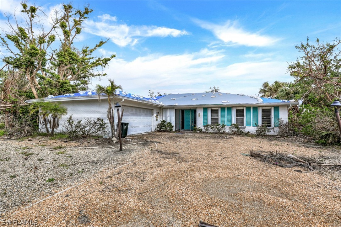 591 Boulder Drive Sanibel, FL 33957 - Photo 15 of 29 front view of a house with a yard