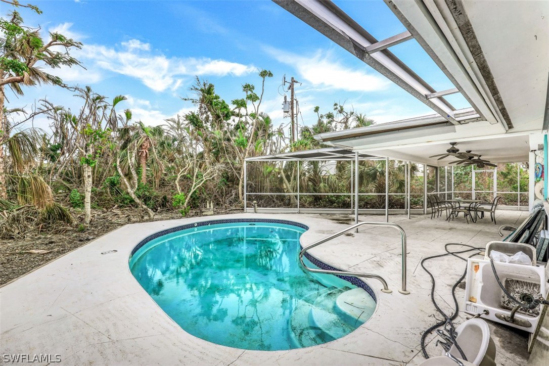 591 Boulder Drive Sanibel, FL 33957 - Photo 27 of 29 a view of a swimming pool with seating area