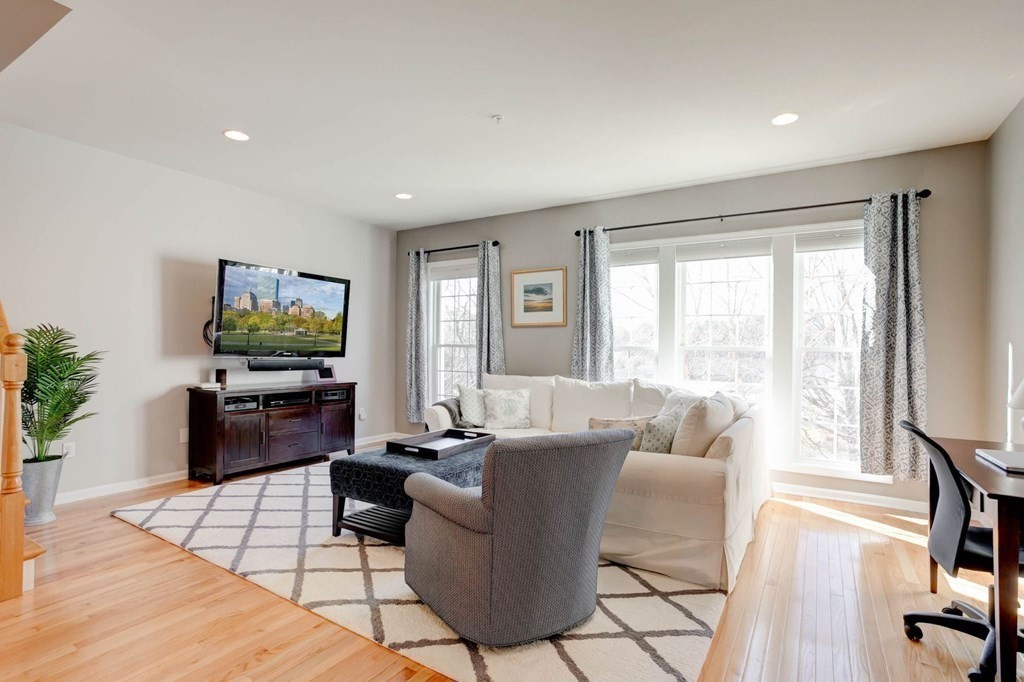 31 Jacob Way, Unit 31 Reading, MA 01867 - Photo 12 of 42 a living room with furniture and a flat screen tv