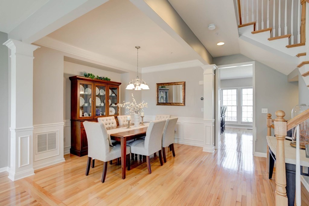 31 Jacob Way, Unit 31 Reading, MA 01867 - Photo 16 of 42 a view of a dining room with furniture a chandelier and wooden floor